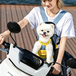 White Pomeranian carried in DONOYOYO blue denim and yellow pet carrier backpack worn chest-facing by a woman on a scooter, ideal for urban travel with small dogs